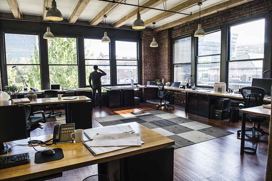 office worker desks surrounded by clear windows